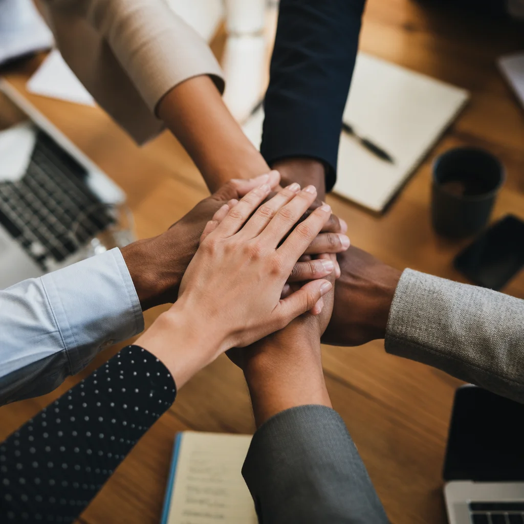 Unified Business Team Hands Over Conference Table