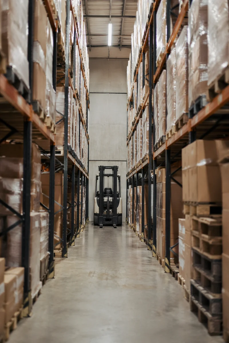 Warehouse Aisle with Forklift and Shipping Boxes
