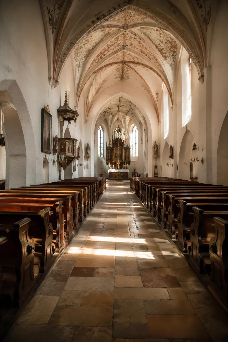 Sunlit Church Aisle Toward Glowing Altar