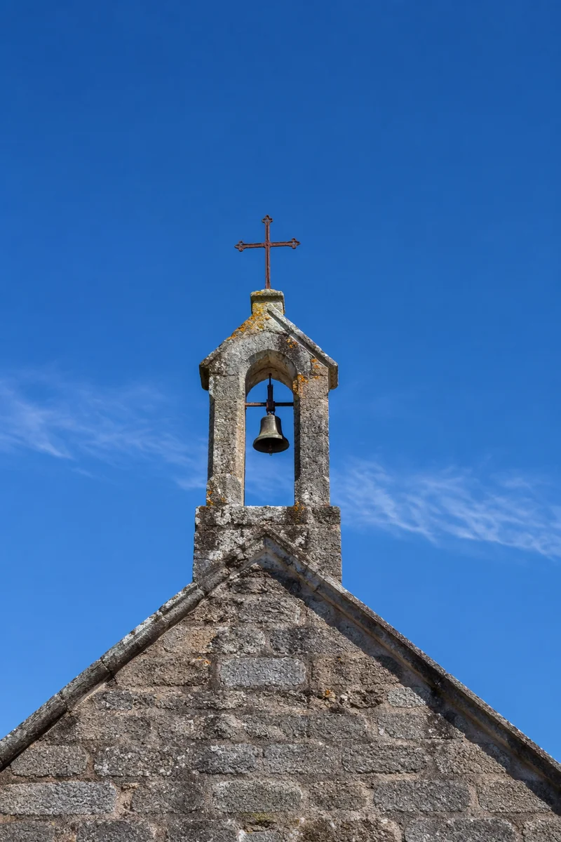 Old Stone Chapel Bell Tower Under Blue Sky
