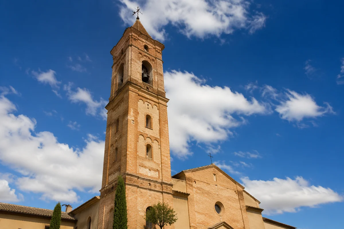 Historic Brick Church Bell Tower Under Blue Sky