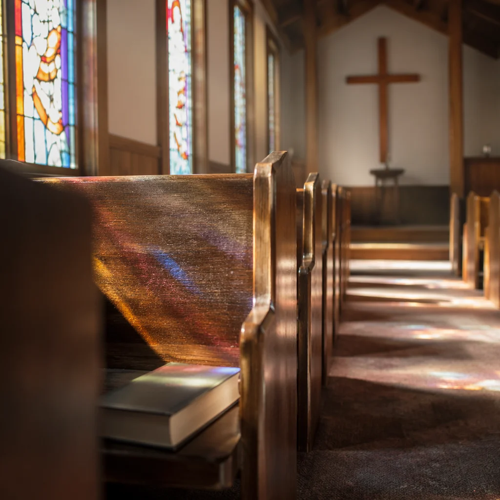 Sunlit Church Pews and Stained Glass