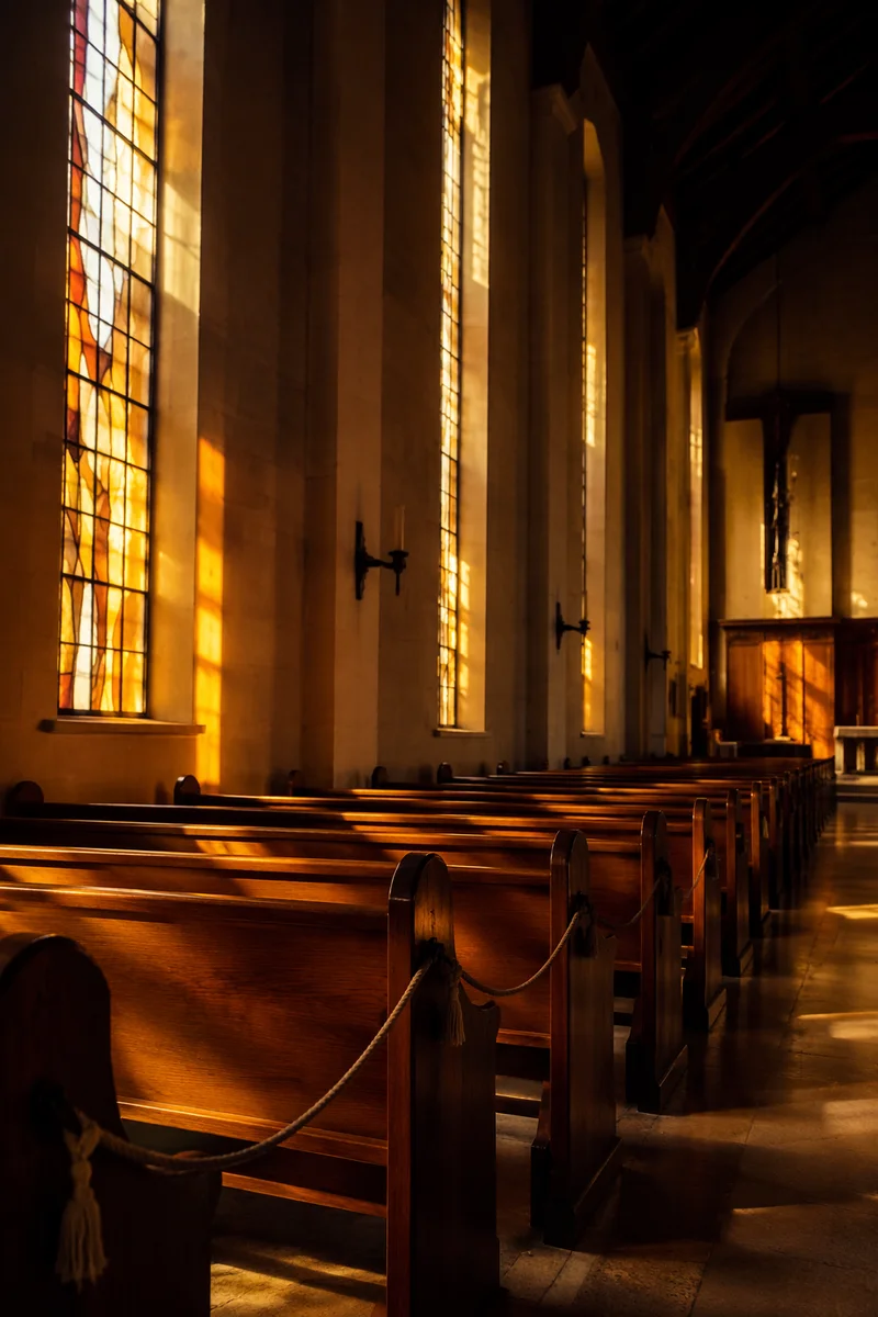 Sunlit Stained Glass Over Empty Church Pews