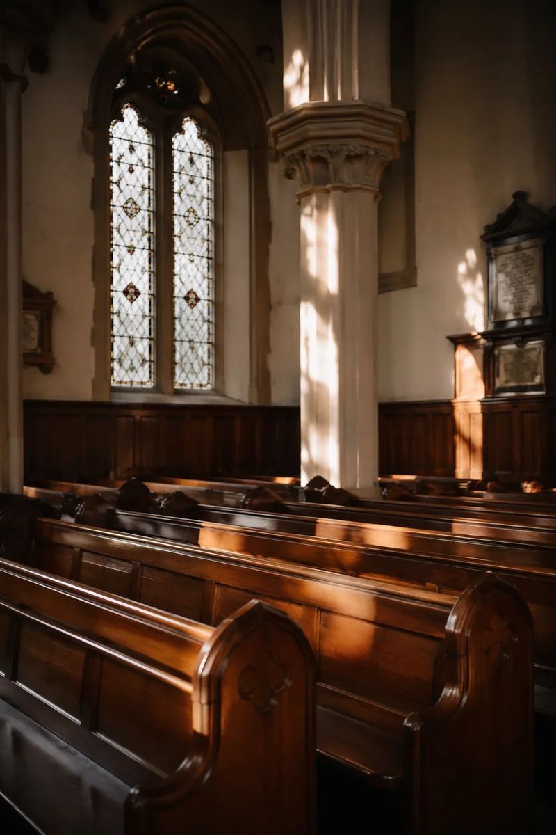 Sunlit Church Pews and Stained Glass
