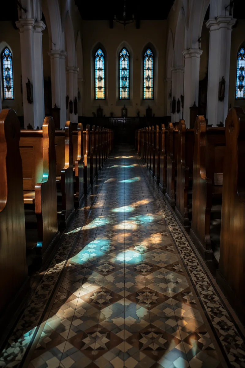 Sunlit Church Pews and Stained Glass