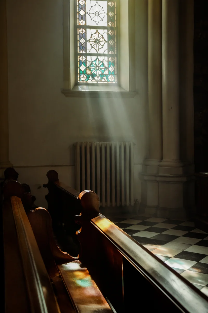 Sunlit Church Pews with Stained Glass