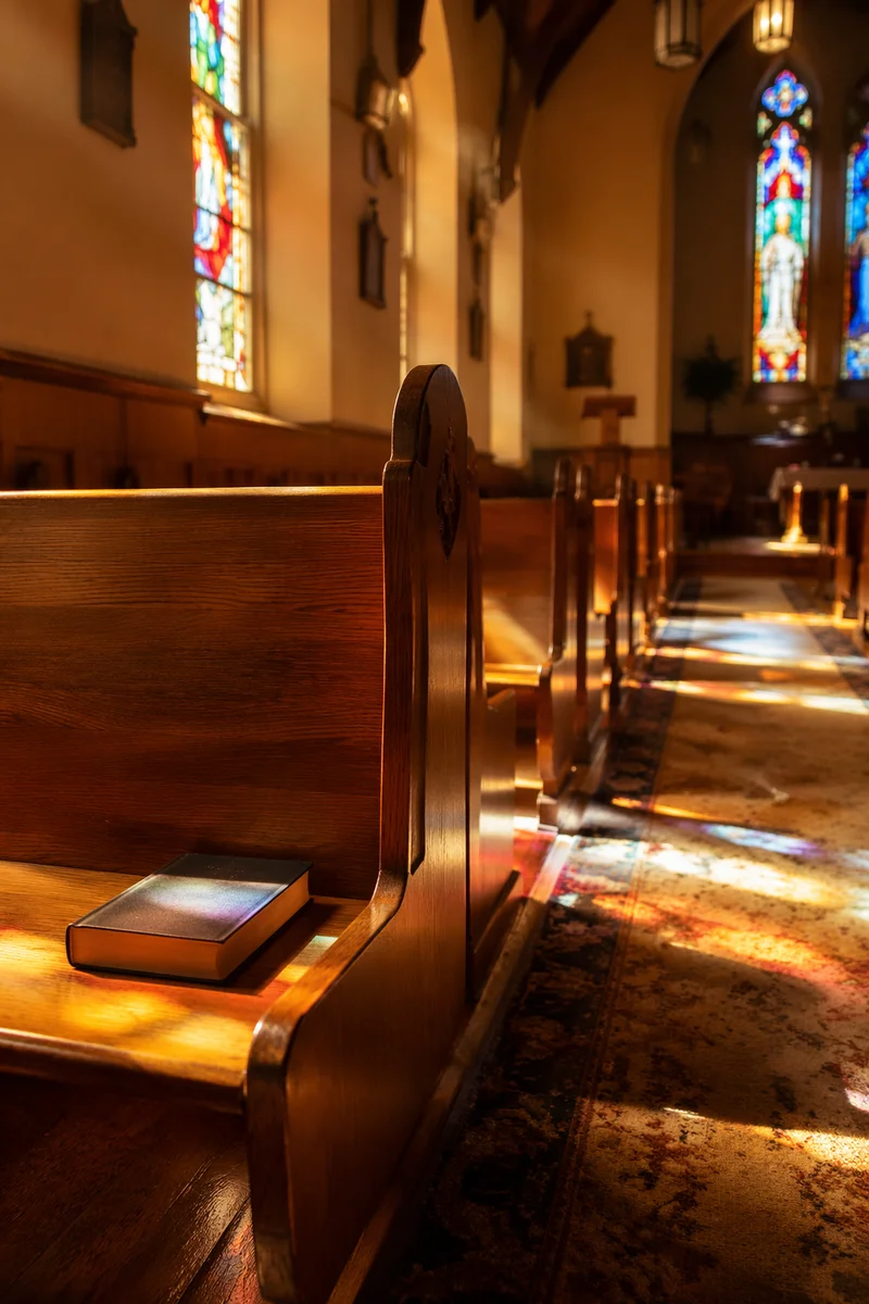 Sunlit Church Pews with Stained Glass