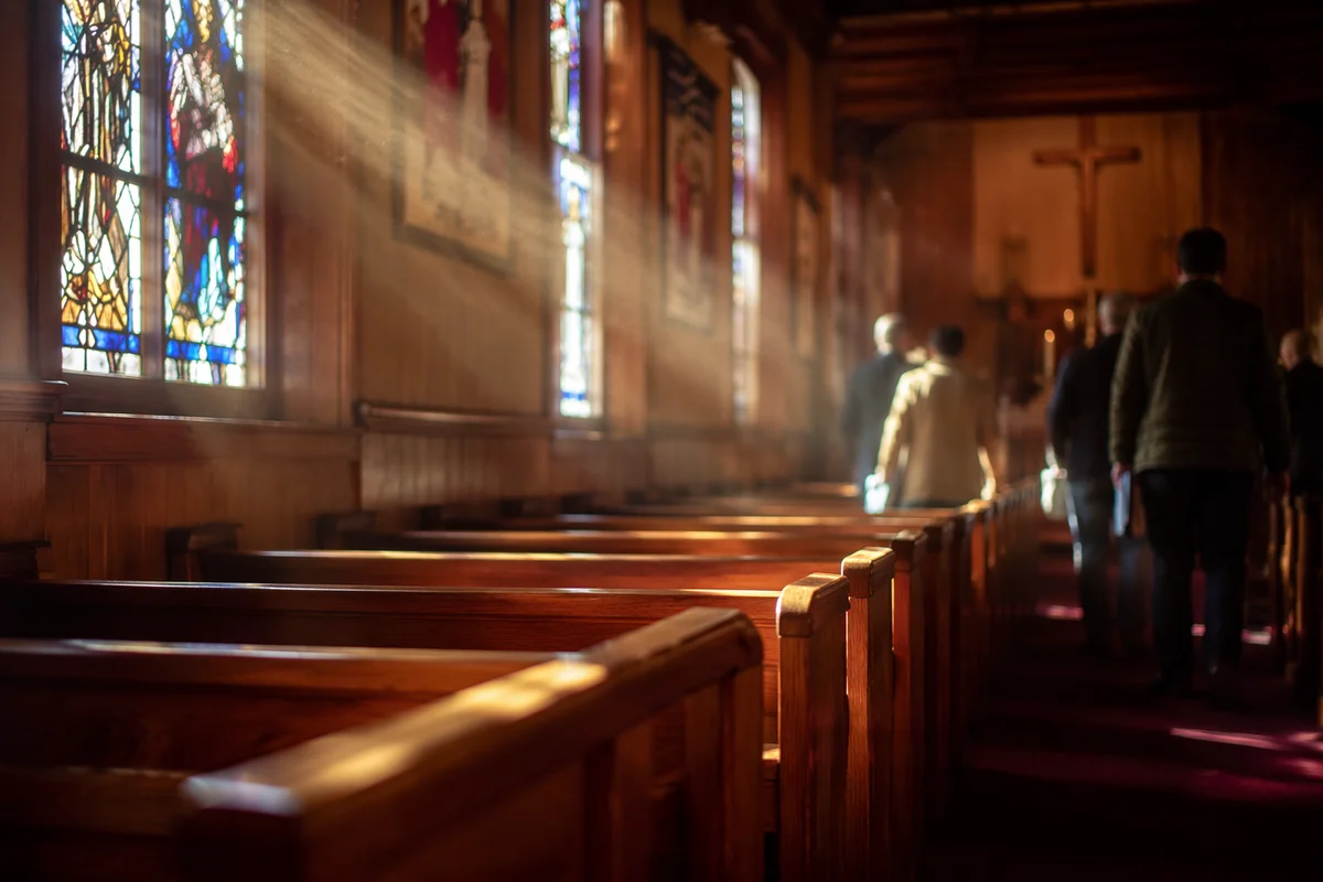 Sunlit Church Pews Beneath Stained Glass