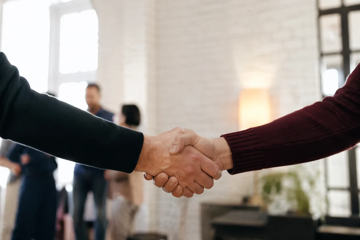 Warm Church Welcome Handshake in Foyer