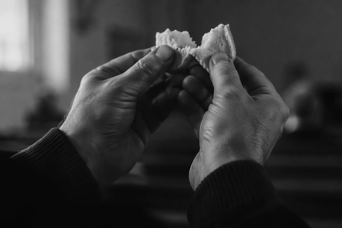 Hands Breaking Communion Bread in Reverence