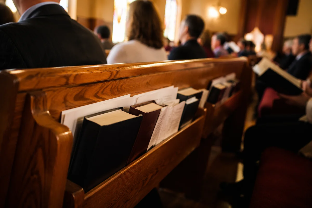 Hymnals Resting in Warm Church Pew