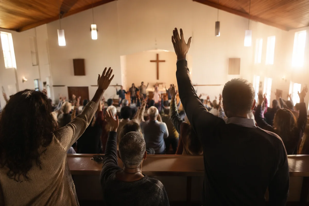 Diverse Congregation Worshiping in Sunlit Chapel