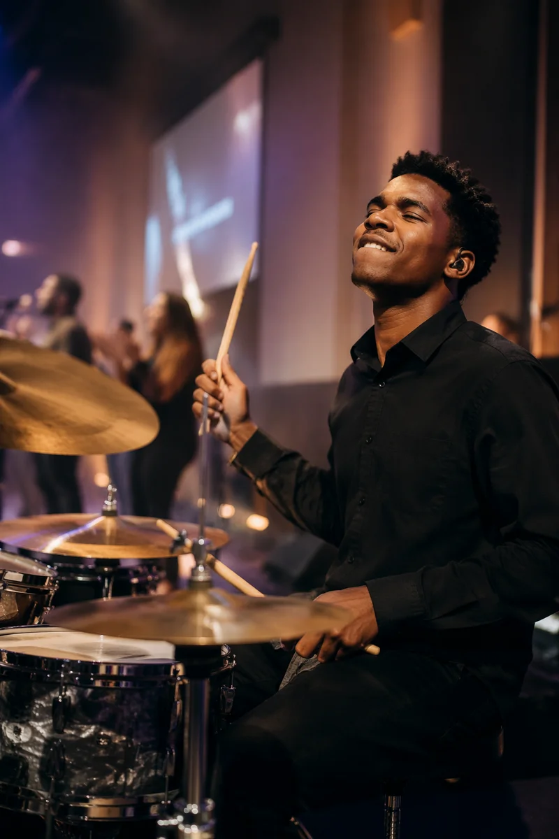 Joyful Drummer on Church Stage