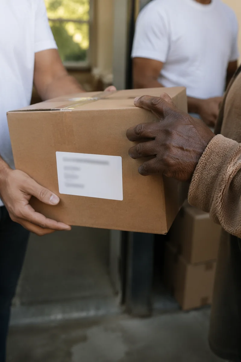 Hands Sharing Food Box in Outreach Ministry