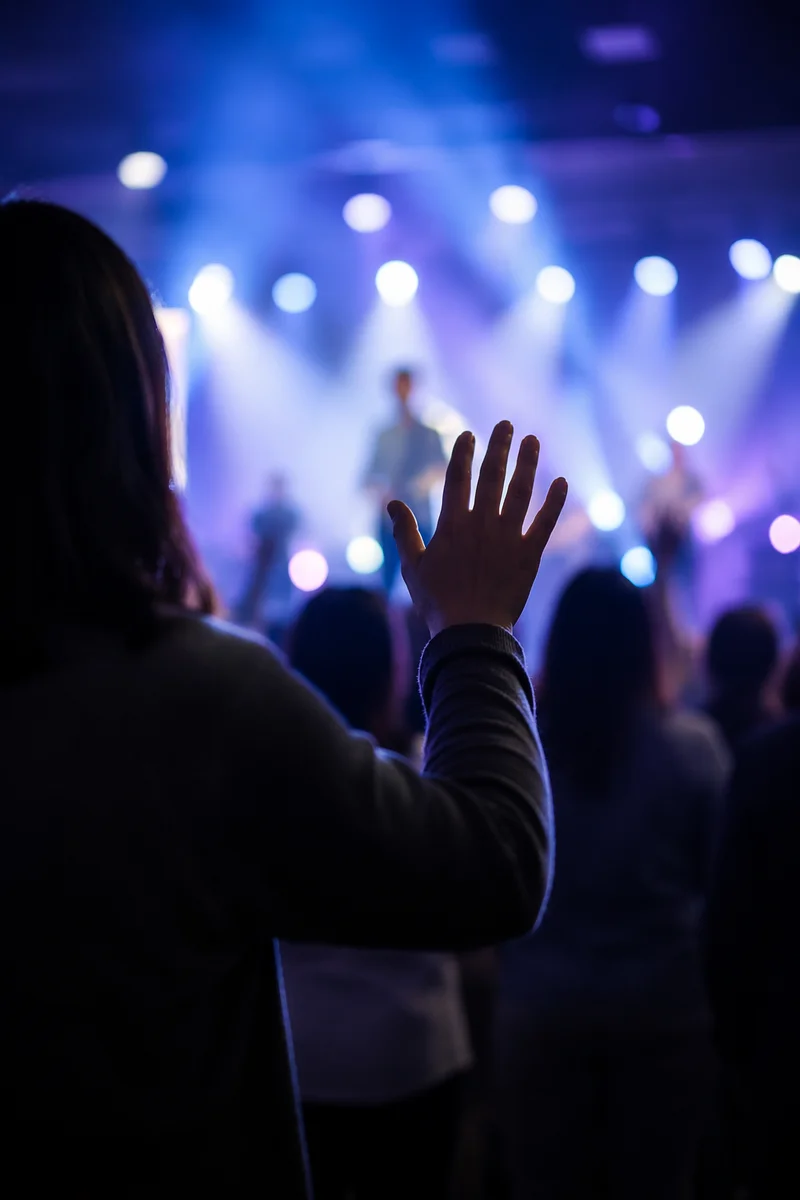 Raised Hands in Worship Concert Lights