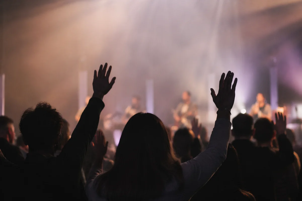 Raised Hands in Warm Worship Lights
