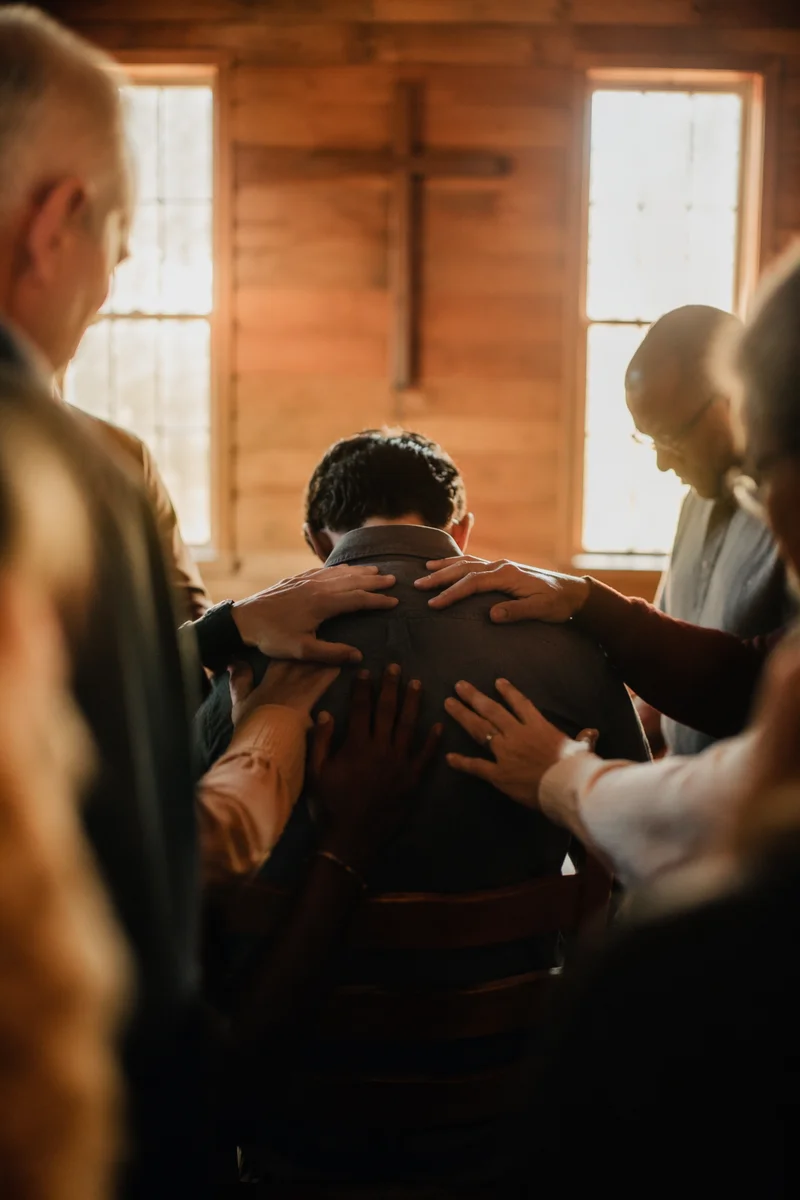 Laying Hands Prayer in Wooden Chapel