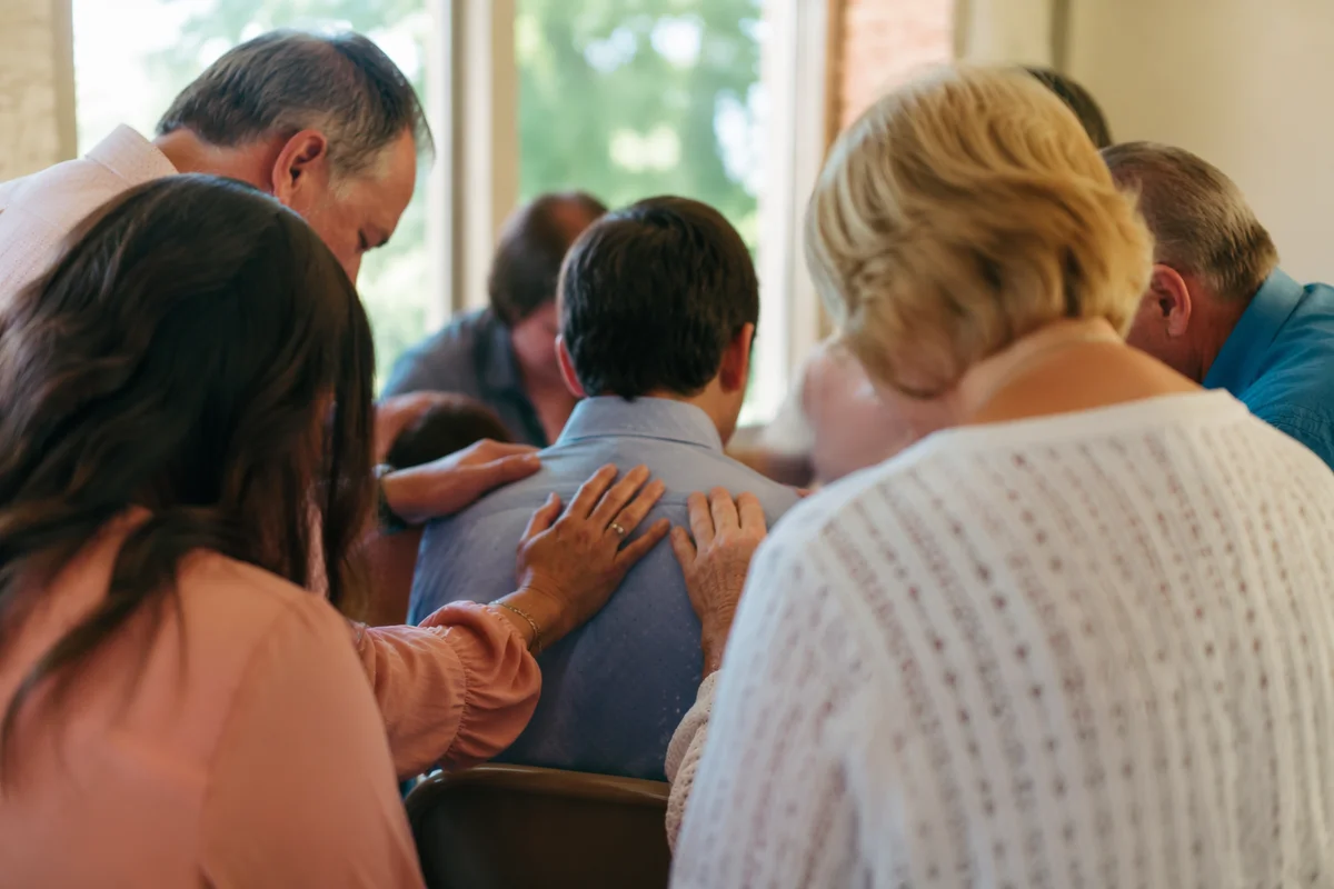 Laying Hands Prayer in Church Fellowship Hall