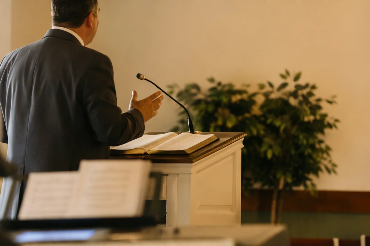 Pastor Preaching at White Church Pulpit