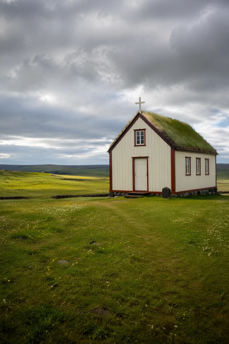 Small Wooden Chapel in Rolling Countryside