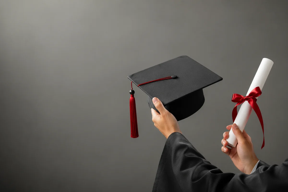 Graduate Hands Holding Cap and Diploma