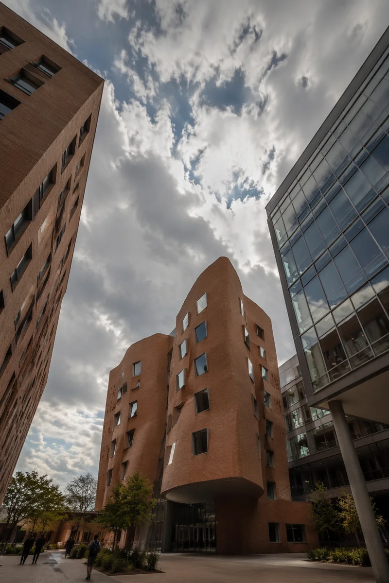 Modern University Courtyard Beneath Cloudy Sky