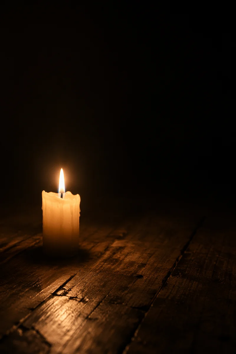 Single Candle Burning in Dark Room