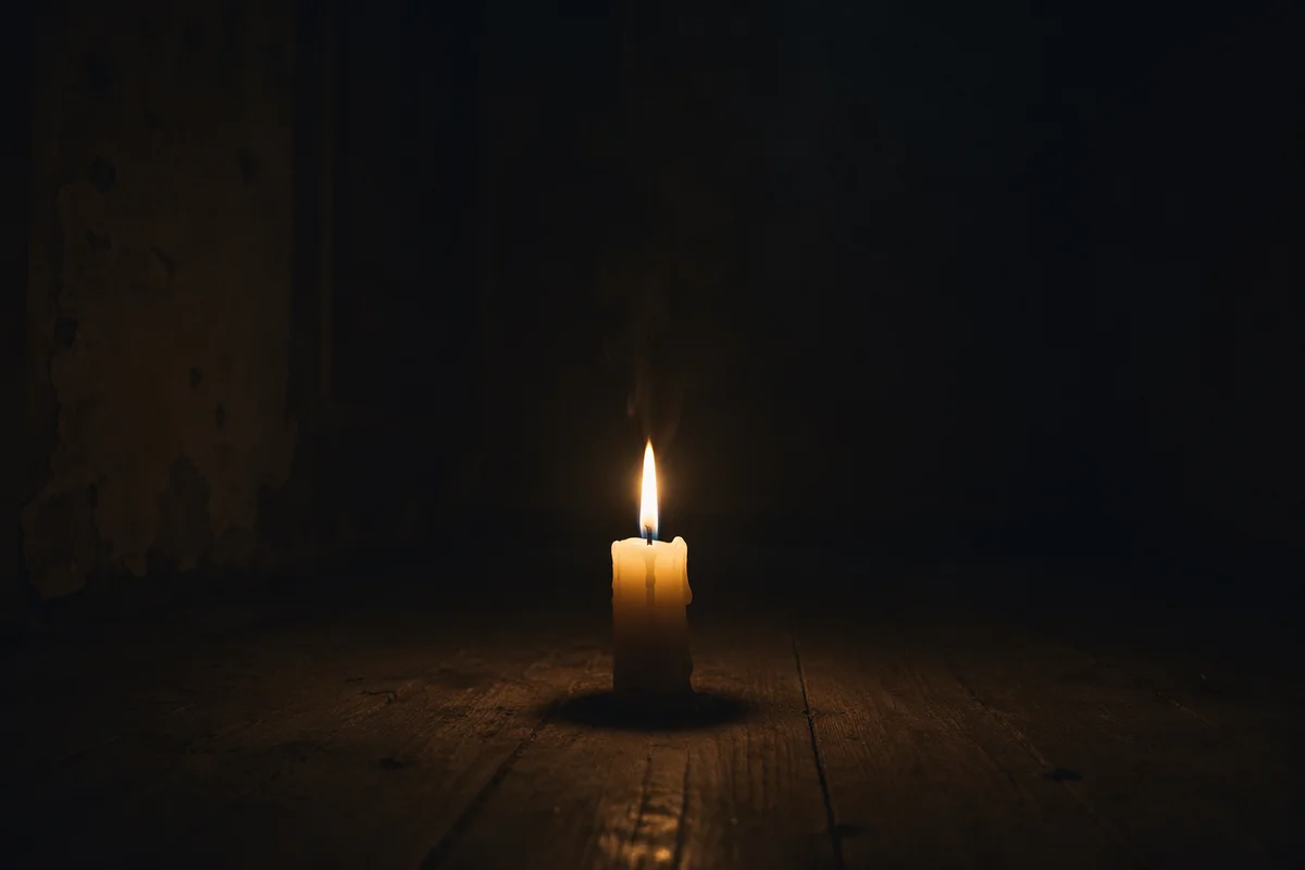 Single Candle Burning in Dark Room