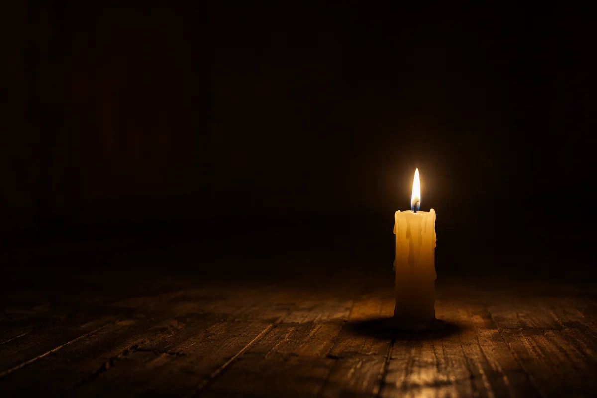 Single Candle Burning in Dark Room