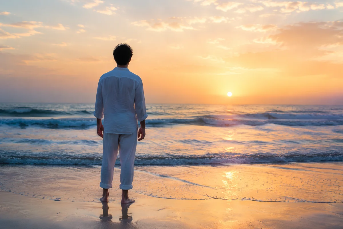 Lone Figure Watching Ocean Sunrise