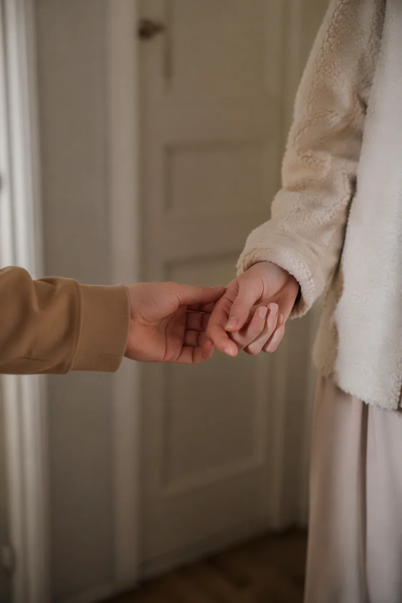 Forgiving Hands in Warm Hallway Light