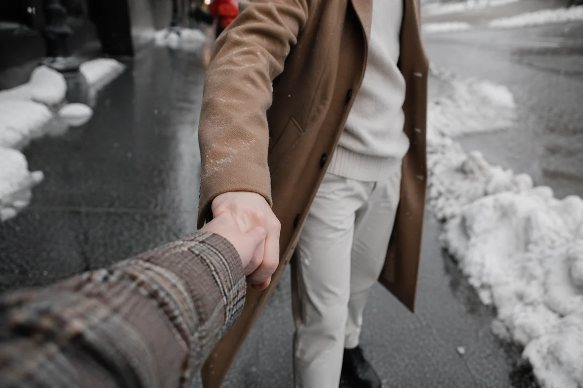 Couple Holding Hands Through Winter Storm
