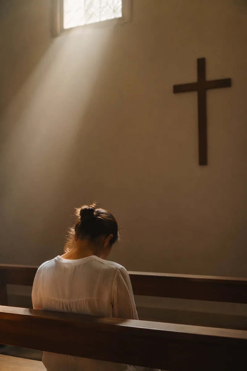 Bowed Prayer in Gentle Chapel Light