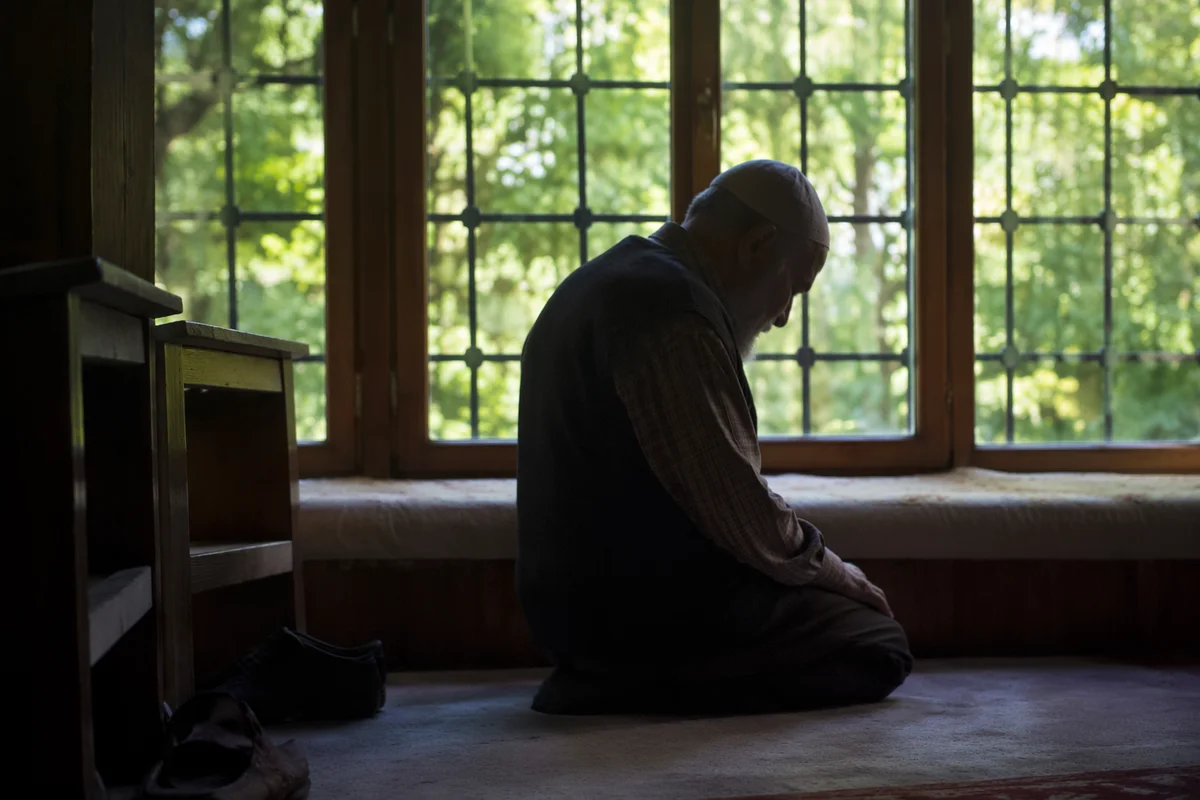 Humble Elder Bowed in Gentle Window Light