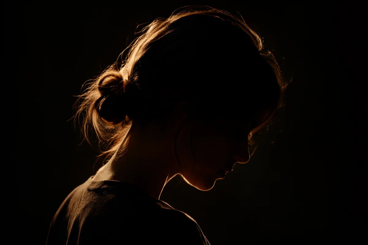 Humble Bowed Head in Gentle Golden Light