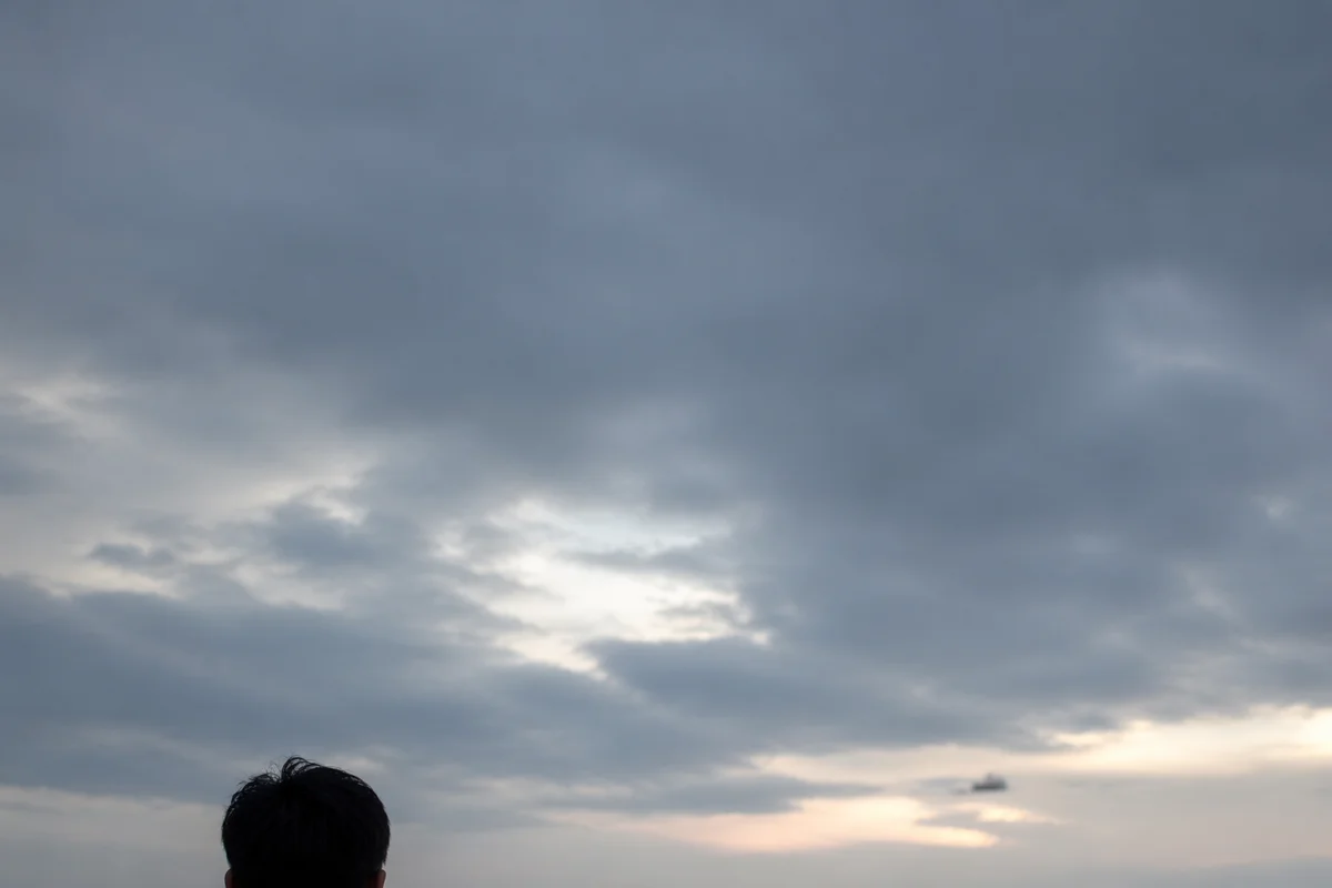 Longing Person Facing an Overcast Horizon