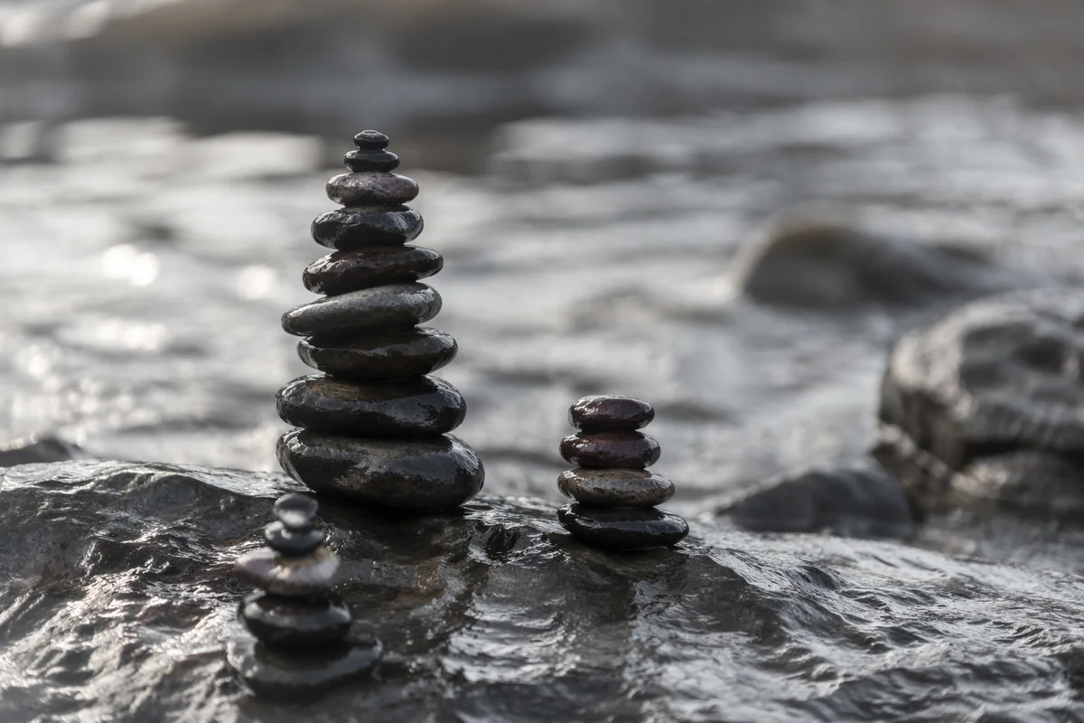 Peaceful Stone Cairns Beside Still Water