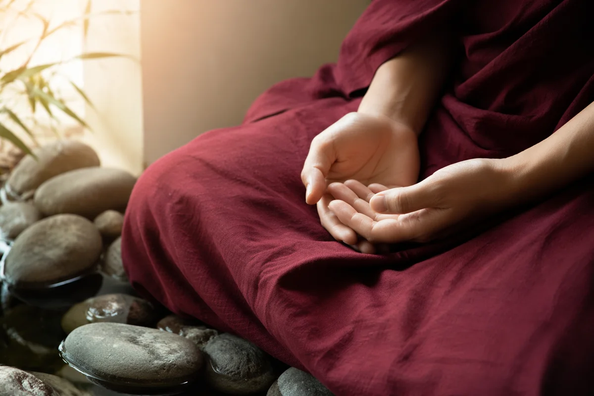 Peaceful Hands Beside Still Water Stones