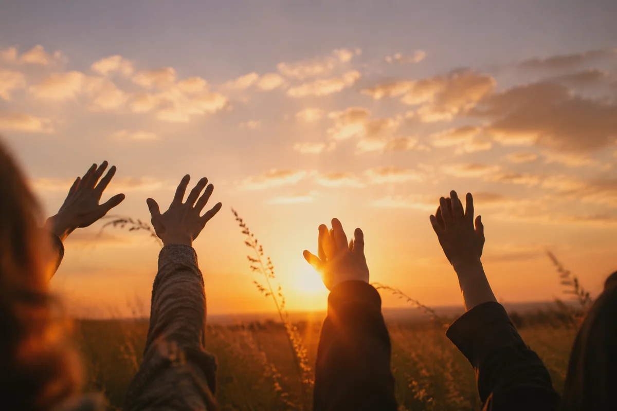 Praise Hands Raised Under Golden Sunset