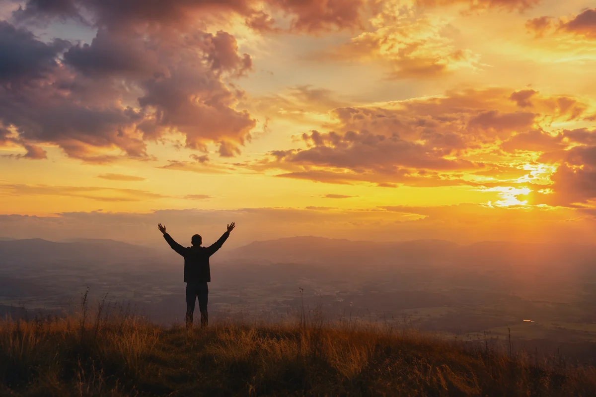 Praise Hands Lifted Beneath Golden Sunset