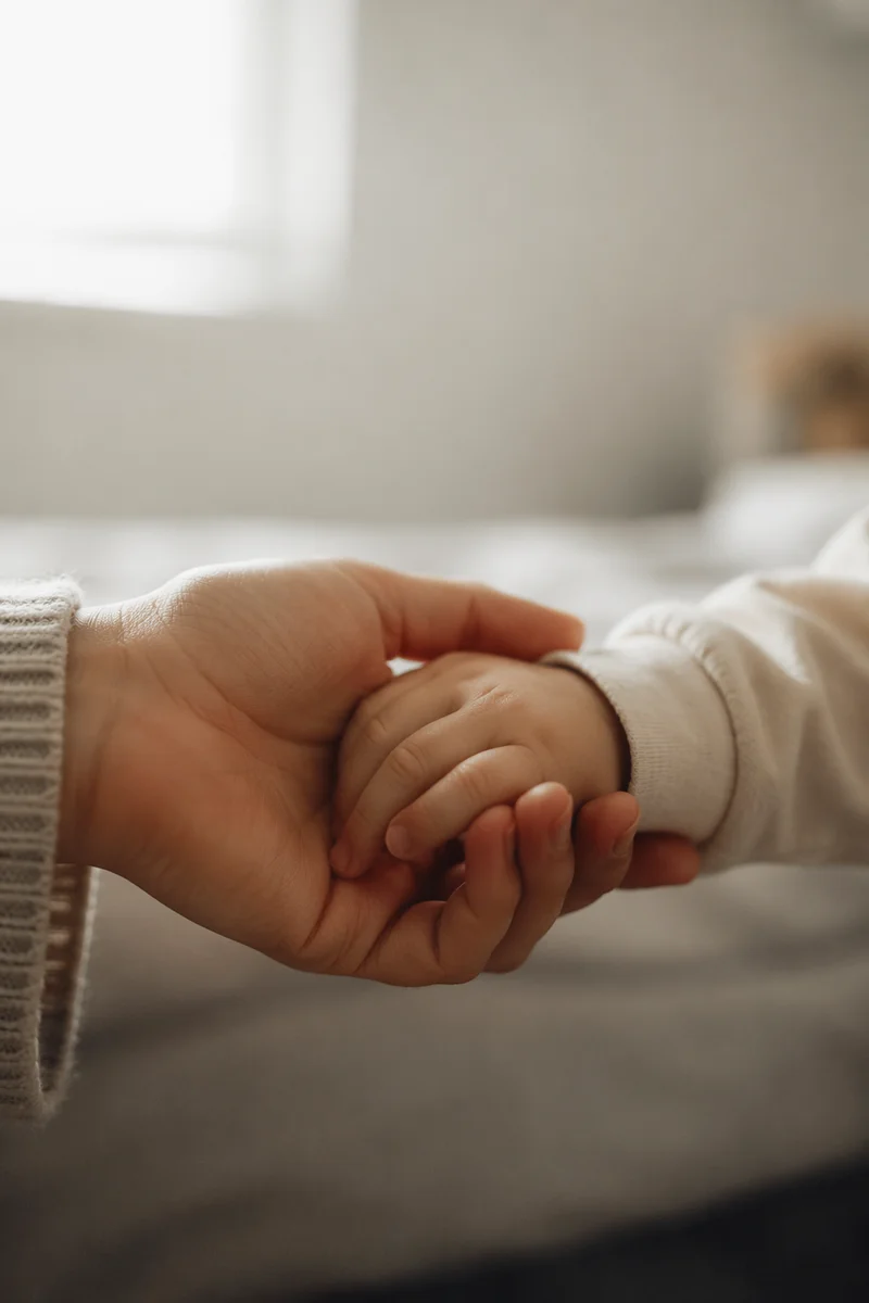 Child Hand Holding Adult Hand in Trust