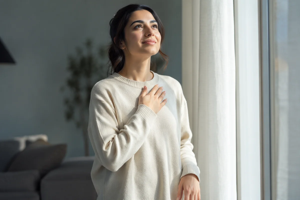 Hopeful Woman Looking Up by Window