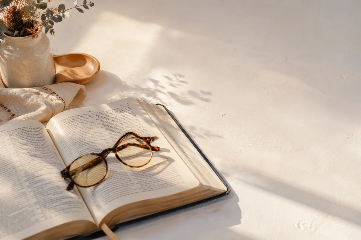 Open Bible and Reading Glasses in Warm Light