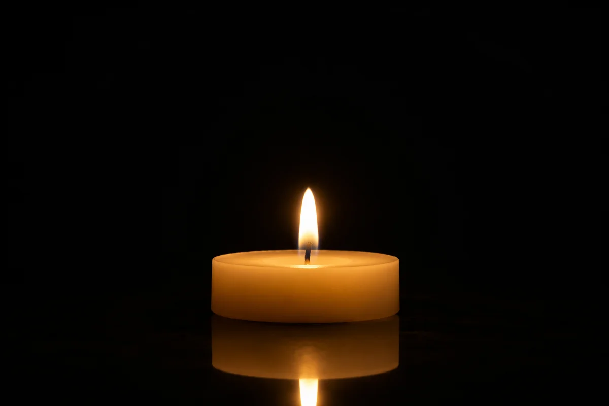 Burning Candle in Quiet Darkness