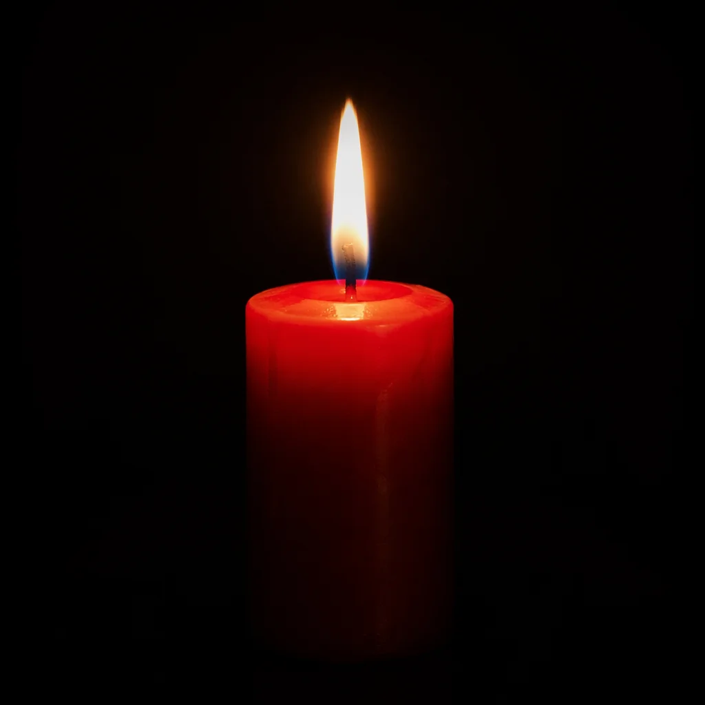 Red Candle Flame in Quiet Darkness