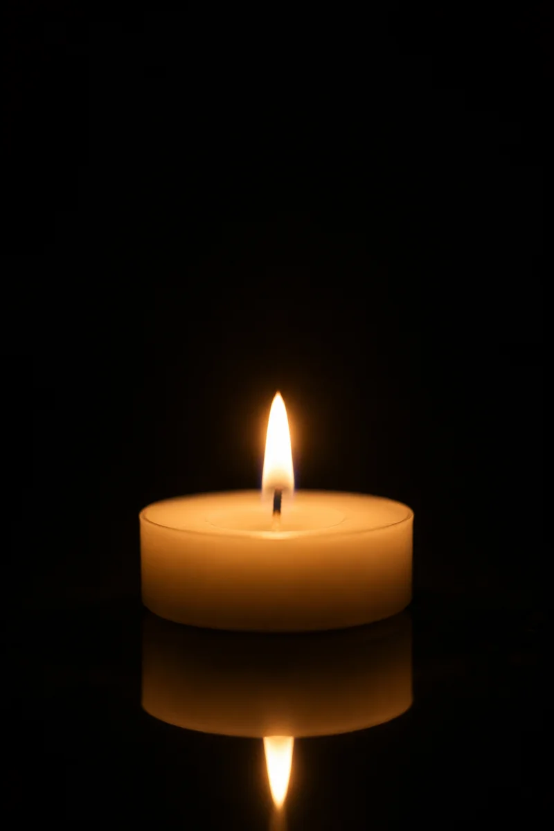 Burning Ivory Candle in Quiet Darkness
