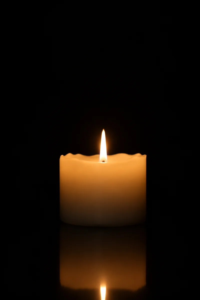 Burning Ivory Candle in Quiet Darkness
