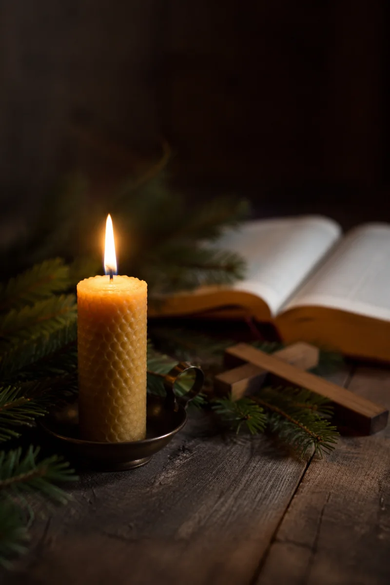 Candlelit Evergreen Devotion on Dark Wooden Table