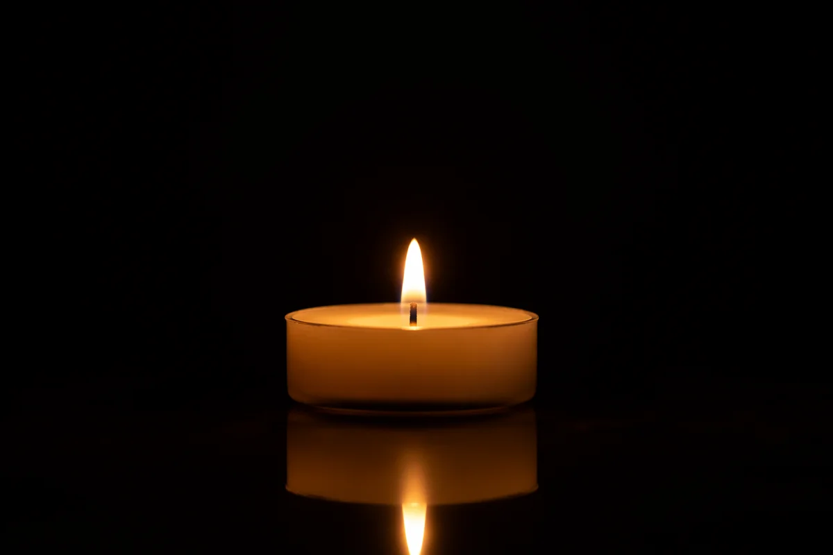 Burning Candle in Quiet Darkness