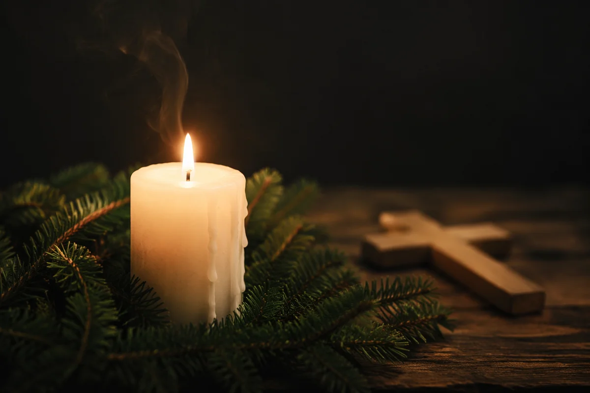 Burning Candle with Evergreen and Cross
